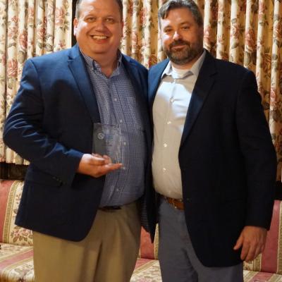 Karl Henley, left, accepts the Individual Donor of the Year Award from board member Aaron Kurchev.
