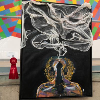 Artwork depicting a woman blowing a cloud of smoke.