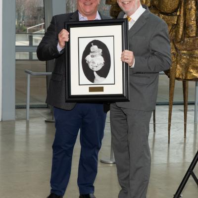 Barry Klein of Klein's Pharmacy and CSS' Michael Gaffney hold up the Best in Show artwork..