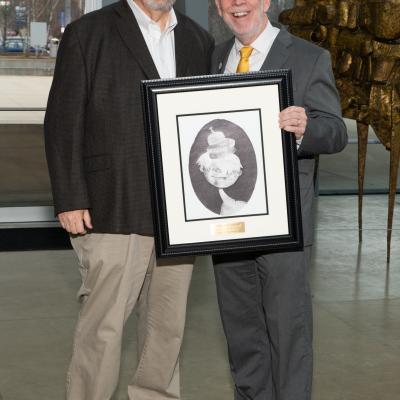 CSS' Michael Gaffney presents Thom Craig of Peg's Foundation with a framed drawing.