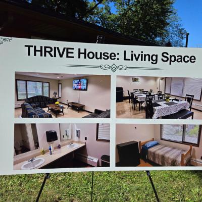 A white sign displays pictures of the home's living spaces.