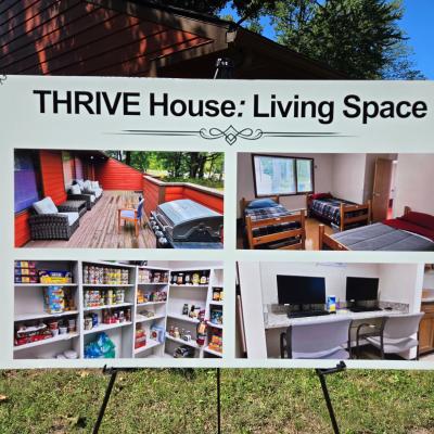 A white sign displays pictures of the home's living spaces.